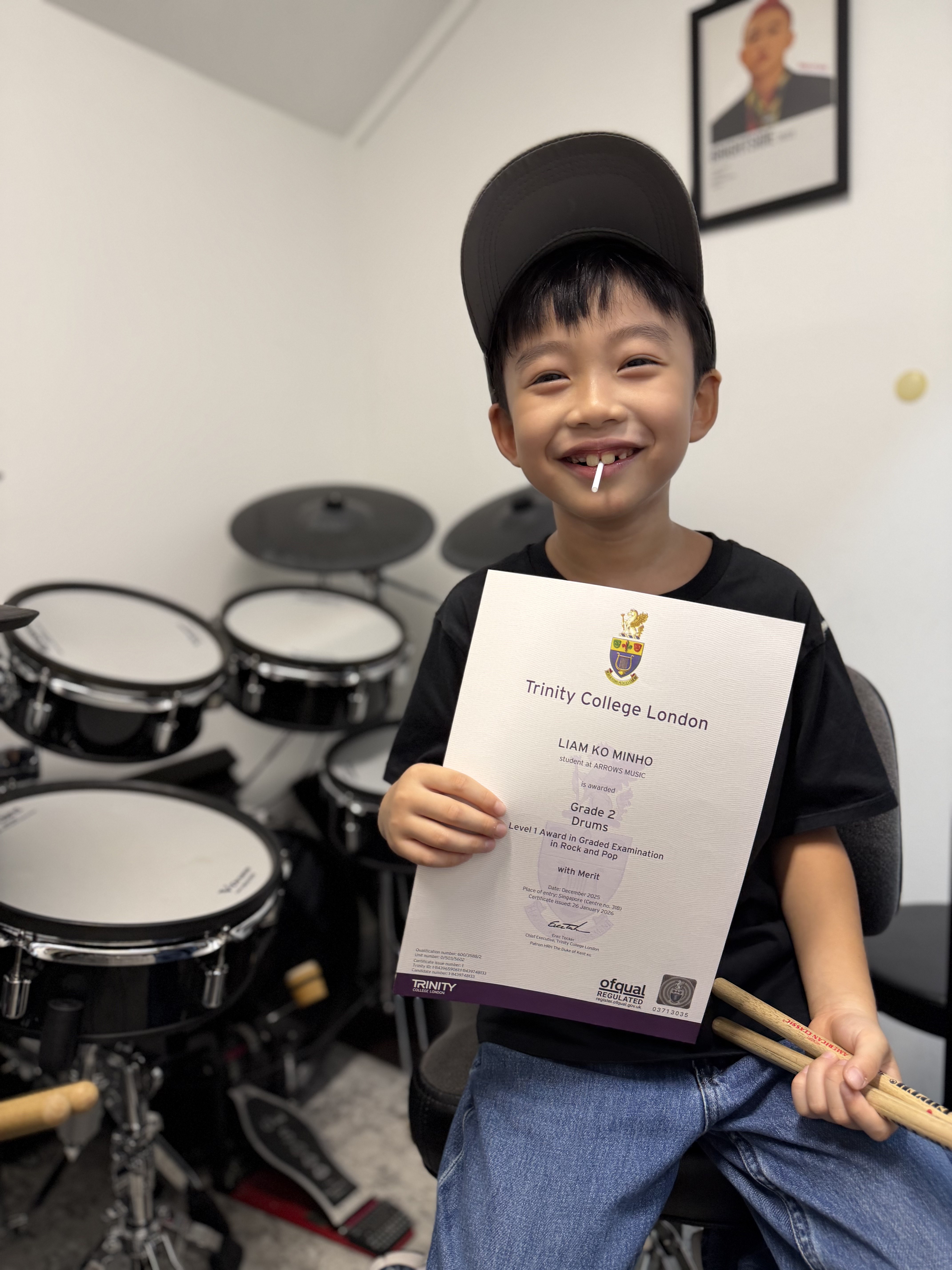 Liam Ko Minho with Trinity Grade 2 certificate